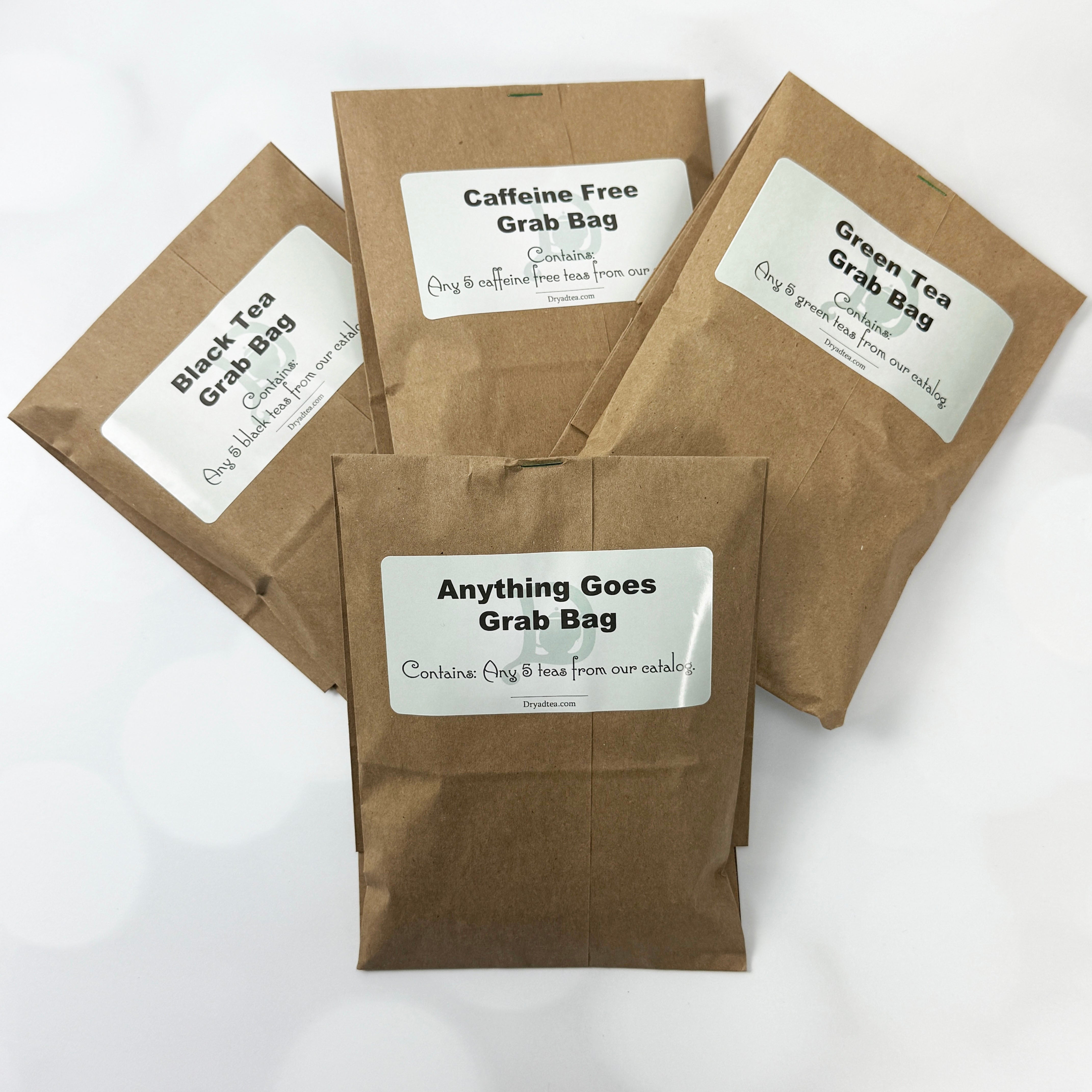 Four brown paper bags labeled with different tea types on a white background