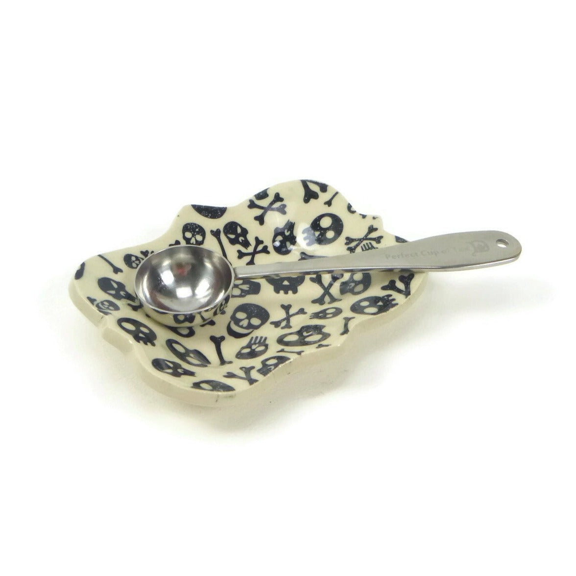 Large scalloped trivet with skull and crossbones patterning